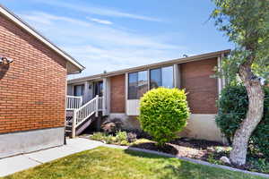 View of front of house featuring a garage, brick siding, and a mountain view