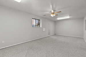 Carpeted bedroom with baseboards and a ceiling fan