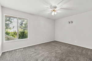 Carpeted bedroom with ceiling fan