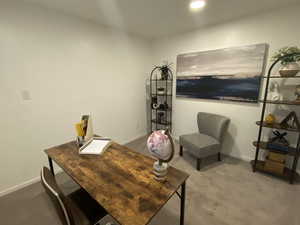 Office with carpet floors and recessed lighting