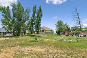 View of grassy yard with an outbuilding