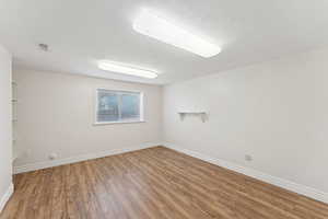 Spare room featuring wood finished floors