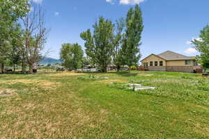View of grassy yard featuring a mountain view