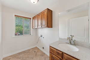 Washroom featuring electric dryer hookup and hookup for a washing machine