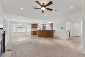 Unfurnished living room with a chandelier, a fireplace, light tile patterned floors, recessed lighting, and ceiling fan
