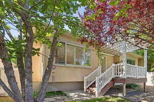 Rear view of property with stucco siding