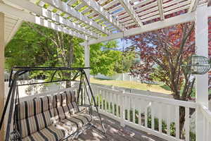 Wooden terrace featuring a pergola