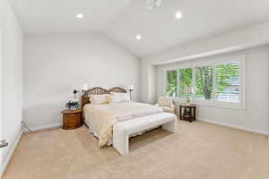 Carpeted bedroom featuring recessed lighting and lofted ceiling