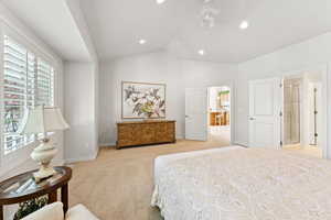 Bedroom featuring light colored carpet, recessed lighting, and high vaulted ceiling