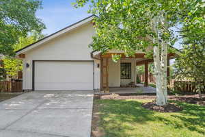 View of front facade with driveway and a garage