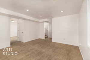Spare room with carpet floors, stairway, and recessed lighting