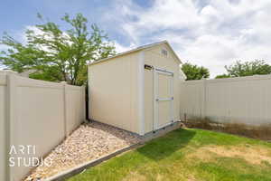 View of shed with a fenced backyard