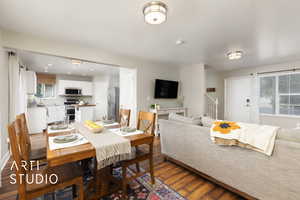 Dining space featuring wood finished floors and stairs