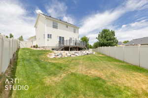 Rear view of house featuring a wooden deck, a fenced backyard, a gate, and stairway