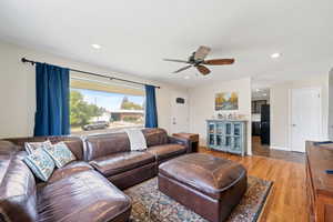 Living area with ceiling fan, light wood-type flooring, and recessed lighting