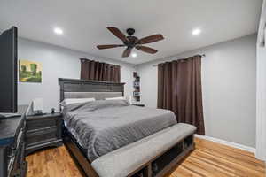 Bedroom with light wood-type flooring, recessed lighting, and ceiling fan
