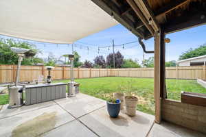 Fenced backyard featuring a patio