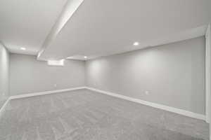 Finished basement with recessed lighting and carpet floors