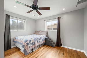 Bedroom with light wood-style flooring, recessed lighting, and a ceiling fan
