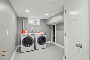Laundry room featuring washer and dryer and recessed lighting