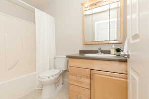 Full bathroom featuring vanity, tile patterned floors, and shower / bath combination with curtain