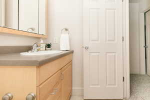 Bathroom featuring vanity and baseboards