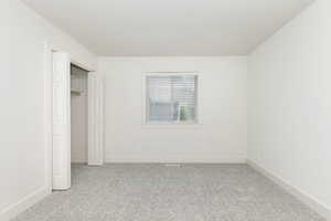 Unfurnished bedroom featuring light colored carpet