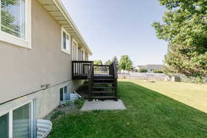 View of yard with a wooden deck and stairs