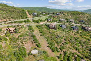Aerial view of property's location with a mountain backdrop