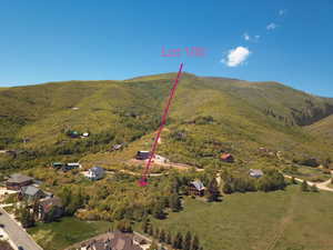 Aerial view of property and surrounding area featuring mountains