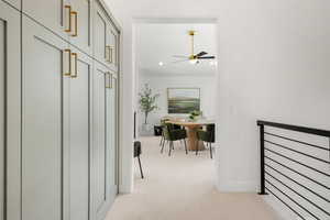 Hallway with light colored carpet and recessed lighting