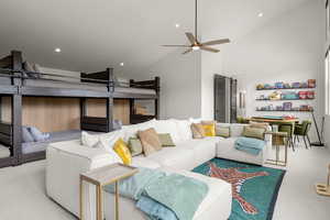 Carpeted bunk room with a ceiling fan, recessed lighting, and high vaulted ceiling