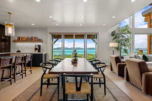 Dining area featuring recessed lighting, light wood-style flooring, and a water view