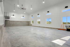 Sports court featuring high vaulted ceiling, concrete floors, and recessed lighting