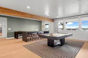 Rec room featuring light wood-style flooring, billiards, recessed lighting, and beam ceiling