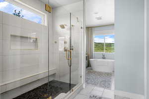Full master bath featuring a shower stall, a soaking tub, and marble look tile flooring