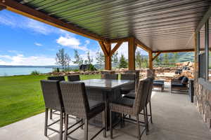 View of patio / terrace with a water view and outdoor dining area