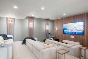 Home theater room with recessed lighting and carpet floors
