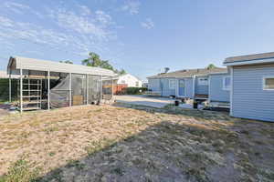 View of the backyard with a patio and 2 car carport