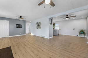 Living room featuring updated lighting, with newer paint and flooring