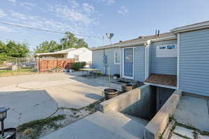 View of patio with entry steps to the crawl space