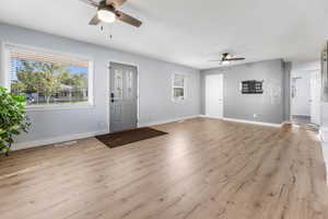 Open concept front entrance with updated lighting and flooring