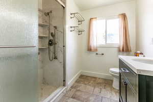 Bathroom featuring a stall shower and vanity
