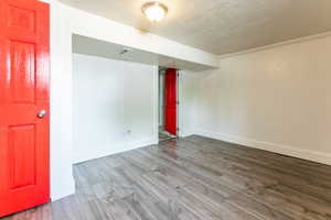 Unfurnished room featuring wood finished floors and a textured ceiling