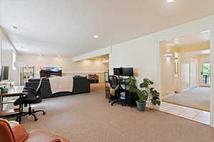 Tiled home office with carpet floors, a textured ceiling, and recessed lighting