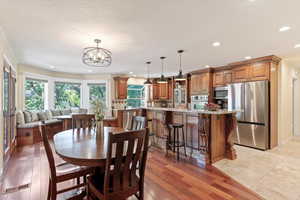 Dining area featuring recessed lighting, a chandelier, and light wood-style flooring