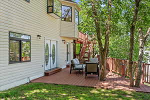 Wooden deck featuring stairs and french doors