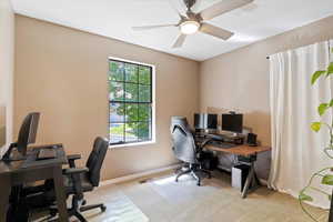 Home office with carpet floors and a ceiling fan