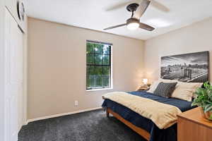Bedroom featuring carpet flooring, a closet, and ceiling fan