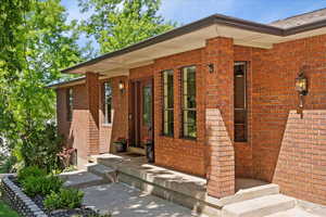 Doorway to property with brick siding